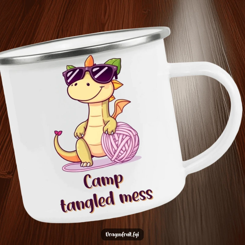 Funny camping mug featuring a dragonfruit in oversized sunglasses, tripping over a giant yarn ball, perfect for embracing outdoor mischief.