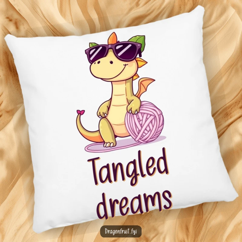 Funny pillow showcasing a dragonfruit with oversized sunglasses and a mischievous grin, tripping over a giant yarn ball, offering comfort and playful humor.