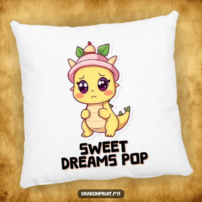 Funny pillow decor featuring a dragonfruit character looking surprised as a cupcake pops out of a hat, adding whimsical comfort and humor.