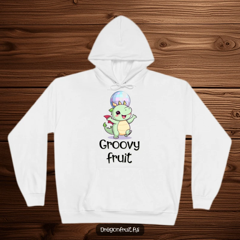 Funny hoodie print of a round dragonfruit character joyfully dancing beneath a sparkling disco ball, radiating party vibes.