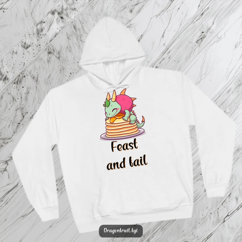 Funny hoodie illustrates a dragonfruit comically tipping over pancakes, wearing a sheepish grin, perfect for cozy, humorous moments.
