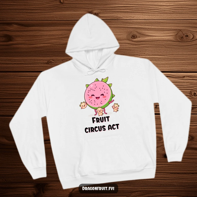 Funny hoodie depicting a smiling dragonfruit slice with tiny legs, juggling smaller segments, offering cozy and tropical humor.