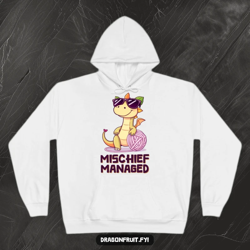 Funny hoodie depicting a dragonfruit with oversized sunglasses and a mischievous grin, tripping over a giant yarn ball, offering cozy and playful humor.